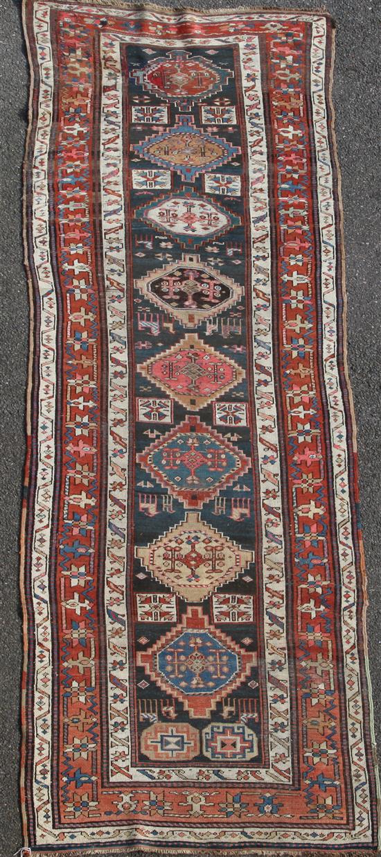 A Kazak blue ground runner, c.1880, 11ft 8in by 3ft 8in.